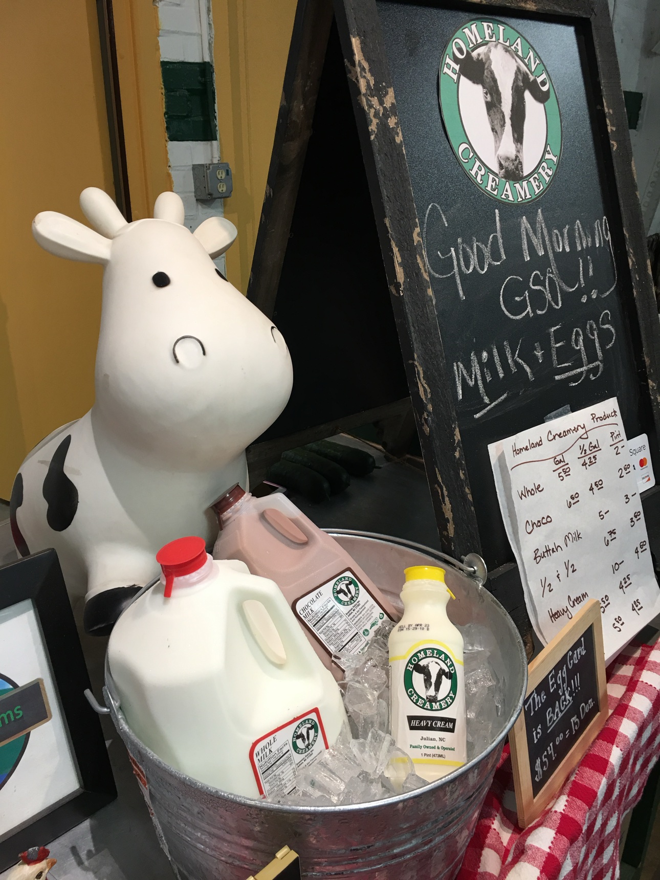 Homeland Creamery milk bottles in an ice bucket at the market booth